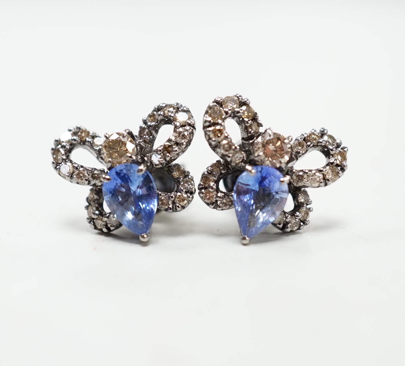 A pair of 750 white metal, sapphire and diamond cluster set bug earrings, width 13mm, gross weight 3.8 grams.